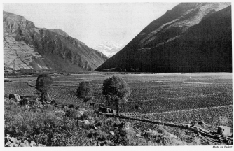 Fig. 43—The floor of the Urubamba Valley from Tarai. The
work of the glaciers was not confined to the lofty situations. Mountain
débris was delivered to all the streams, many of which aggraded their
floors to a depth of several hundred feet, thus increasing the extent of
arable soil at elevations where a less rigorous climate permits the
production of crops and encourages intensive cultivation.